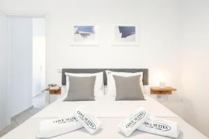 a white bedroom with a bed with two pillows at Cove Suites Apartment in Iraklitsa +22 photos