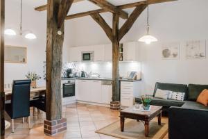 a kitchen and living room with a couch and a table at Ferienhof Werner in Emstek