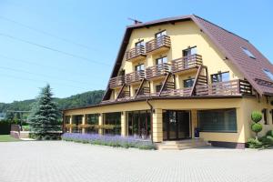 a building with balconies on the side of it at Vila Trapez in Braşov