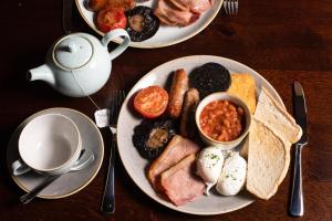 two plates of breakfast food on a wooden table at The Seaburn Inn - The Inn Collection Group in Sunderland +28 photos
