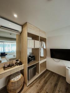 a kitchen with a sink, a refrigerator, and a dishwasher at NORN Nimman13 Boutique Hotel Chiang Mai in Chiang Mai