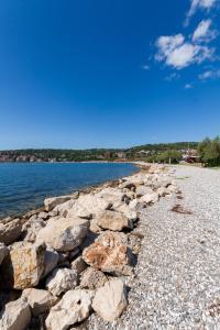 a group of rocks on the shore of a lake at Premium Marina Apartments with Sea View by Locap Group in Portorož