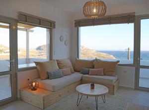 a living room with a couch and a table at Aqua Bliss in Xerokampos