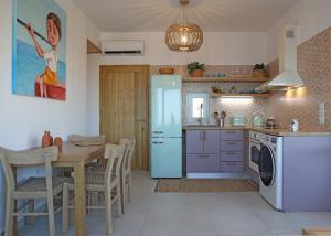 a kitchen with a table and a dining room at Aqua Bliss in Xerokampos