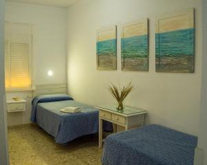 Cama o camas de una habitación en Hostal Patio Andaluz