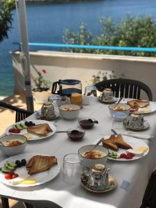 a table with plates of food on top of it at Sea Breeze Villa in Sarandë