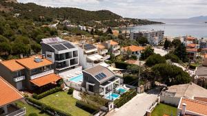 an aerial view of a house with solar panels on its roof at Cove Suites Apartment in Iraklitsa