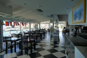 a restaurant with a lot of tables and chairs at Republika Hotel in Sarandë