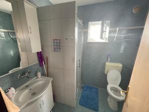 a bathroom with a sink and a toilet and a shower at Apartmani Mirela in Krk +21 photos