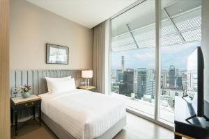 Postel nebo postele na pokoji v ubytování Magnolias Ratchadamri Boulevard Serviced Residences + 37 fotografií