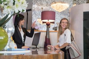 two women sitting at a desk in an office at Hotel Eden in Bellaria-Igea Marina
