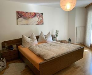 Un dormitorio con una cama grande con almohadas. en Cadras, en Tinzen