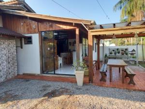 a house with a table and a patio at Loft praia Porto Belo in Porto Belo