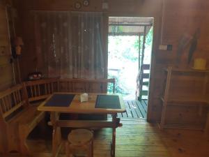 a wooden table in a room with a wooden floor at Domek w lesie in Aleksandrów +7 photos