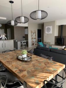 uma sala de estar com uma mesa e um sofá em CAG The Hub Bryanston em Joanesburgo