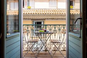 Un balcón con una mesa con fruta. en Le Secret de la Taverne - Netflix/Wifi - Chasse Aux Trésor à l'intérieur, en Carcassonne