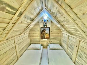a tiny house with two beds in the attic at Camping Albania-Secret Village Den in Sarandë