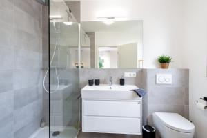 a bathroom with a sink and a shower at Modernes Apartment *Liobablick Nr. 4* - FeWo in Fulda/Petersberg in Petersberg +17 photos
