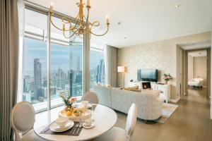 a living room with a couch and a table at Magnolias Ratchadamri Boulevard Serviced Residences in Bangkok