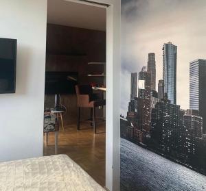 a bedroom with a view of a city at Apartman ANN in Pančevo