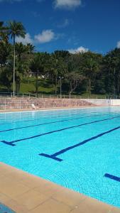 a large swimming pool with blue water at Hotel SESI Valença in Valença