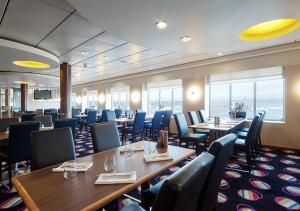 a dining room with tables and chairs in a restaurant at Viking Line ferry Viking XPRS - Night Cruise from Helsinki in Helsinki