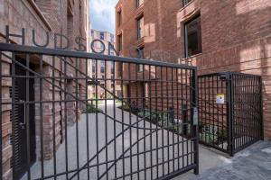 a black metal gate in a street with buildings at City Apartments - Hudson Quarter in York