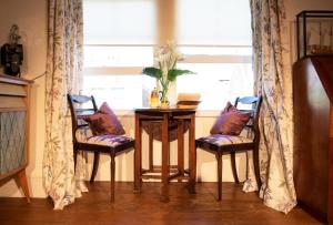 a table and two chairs in a room with a window at Birch in the Lanes in Brighton & Hove