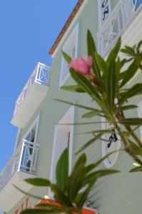 a building with a pink flower in front of it at Hostal Doña Antonia in Punta Umbría