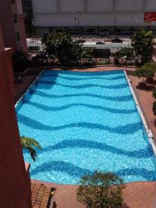 an overhead view of a large blue swimming pool at Homestay Serviced Apartment - Marina Court in Kota Kinabalu