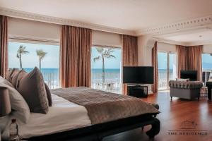 a bedroom with a bed and a view of the ocean at The Residence by the Beach House Marbella in Marbella