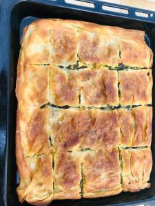 a baking pan filled with a baked pastry in it at Guest House Qafe Dardha - Tomorr National Park in Dardhë