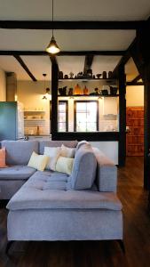 a living room with a couch in the middle of a room at Stay At This Magnificent 100 Year Old Barn in Ruciane-Nida