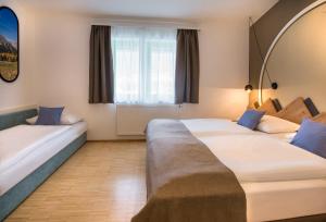 Posteľ alebo postele v izbe v ubytovaní JUFA Hotel Wipptal