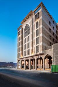 a large building on the side of a street at Faraj Almadina Hotel in Medina