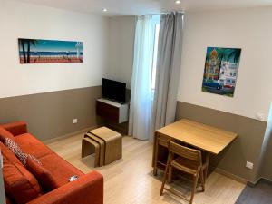 a living room with a couch and a table at Share Inn Appartements in Nice