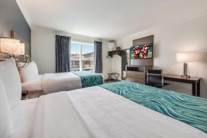 a hotel room with two beds and a desk and a window at Le Voyageur - a Red Collection Hotel in Wildwood +38 photos