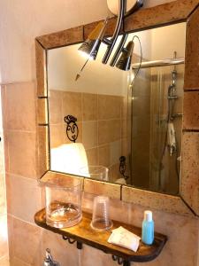 a bathroom with a mirror and a sink at Villa Almoezia Charming B&B in Taormina