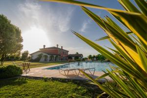 une maison avec une piscine en face d'une maison dans l'établissement Villa San Pietro, à Desenzano del Garda