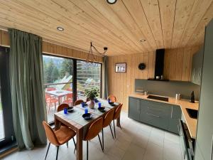 a kitchen and dining room with a table and chairs at Hotel Zerrenpach Látky in Látky