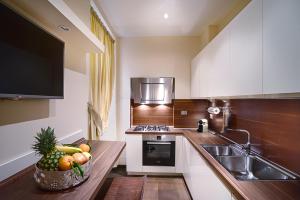 a kitchen with a bowl of fruit on a counter at Frezza Apartment - Alta Luxury Apartments in Rome