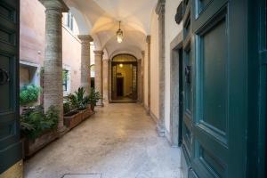 an empty hallway in a building with a blue door at Frezza Apartment - Alta Luxury Apartments in Rome