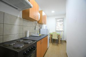 a kitchen with a stove and a counter top at Apartman 59 in Kladovo