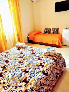 a bedroom with two beds and a quilt on a bed at Bed & Breakfast Delle Palme in Trapani