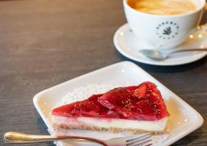 a piece of cake on a plate next to a cup of coffee at Viking Line ferry Viking XPRS - One-way journey from Helsinki to Tallinn in Helsinki