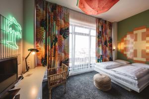 a bedroom with a bed and a large window at Superbude Hamburg Altona in Hamburg