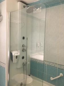 a bathroom with a glass shower with a toilet at Hotel Eken Prestige in Bandırma