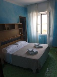 Voodi või voodid majutusasutuse Albergo Stella Di Mare toas