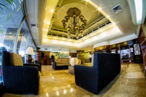 a lobby with couches and a chandelier at Copacabana Apartment Hotel - Staycation is Allowed in Manila