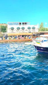 dos barcos están atracados en un cuerpo de agua en Liman Hotel Gümüslük - Adult Only en Bodrum